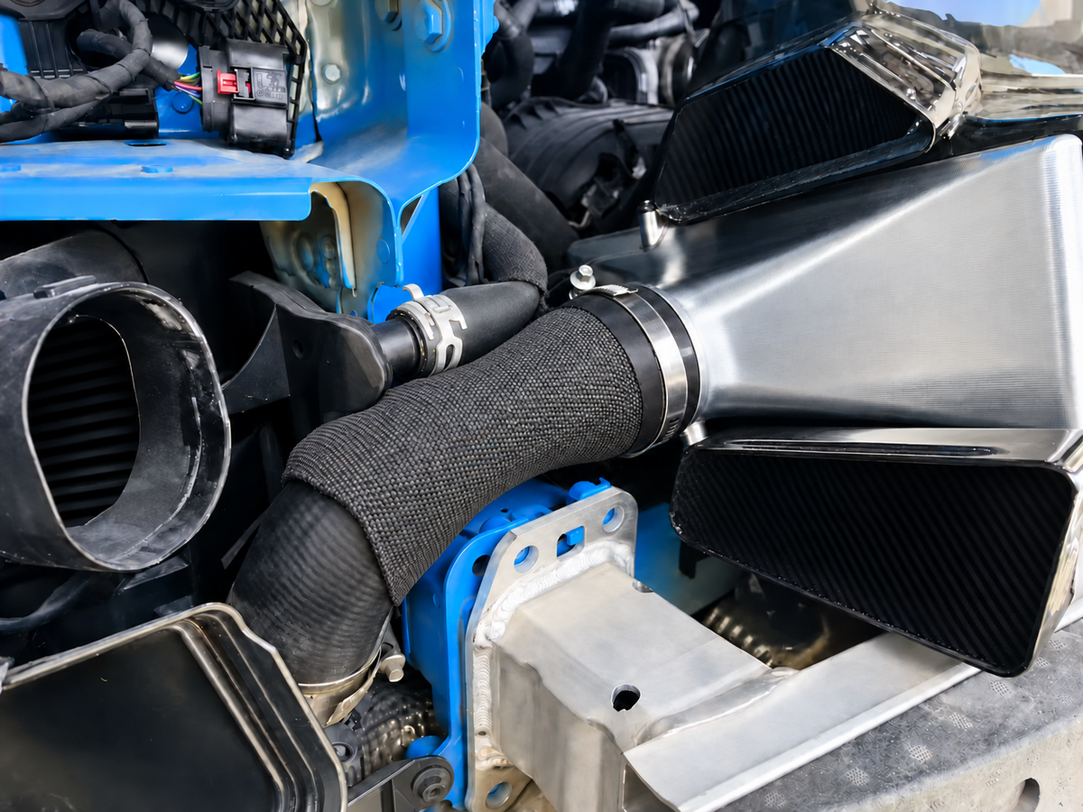 Porsche 992 Turbo performance intercooler charge air connection and installed carbon shield detail