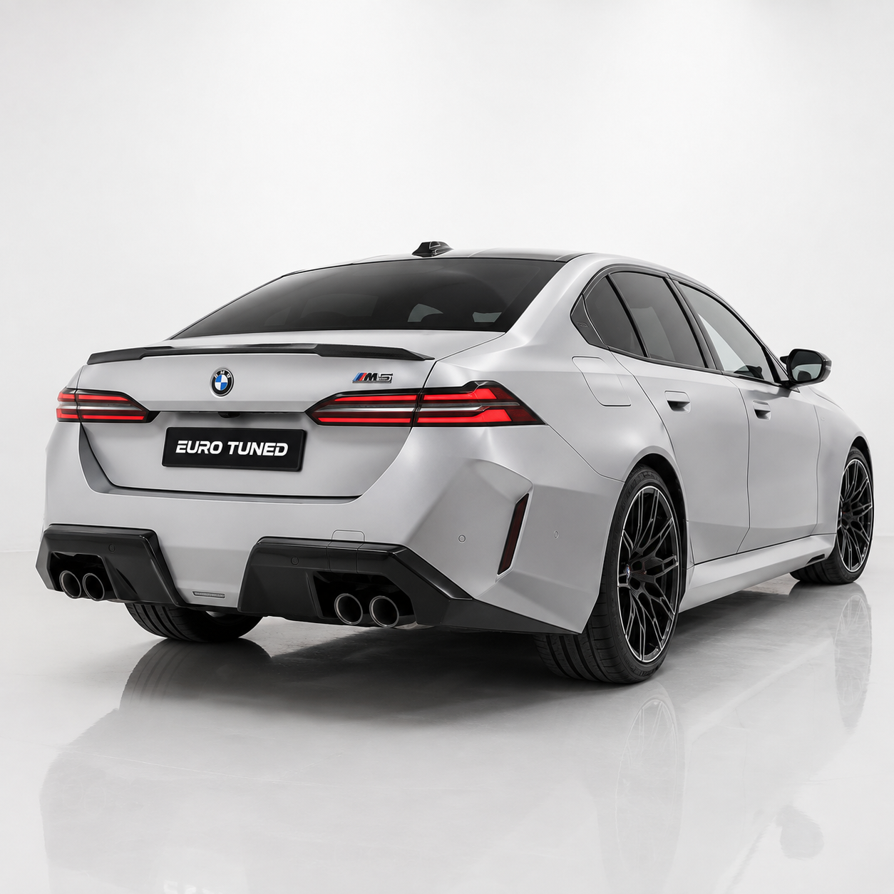 BMW M5 G90 carbon fiber rear trunk spoiler installed three-quarter view