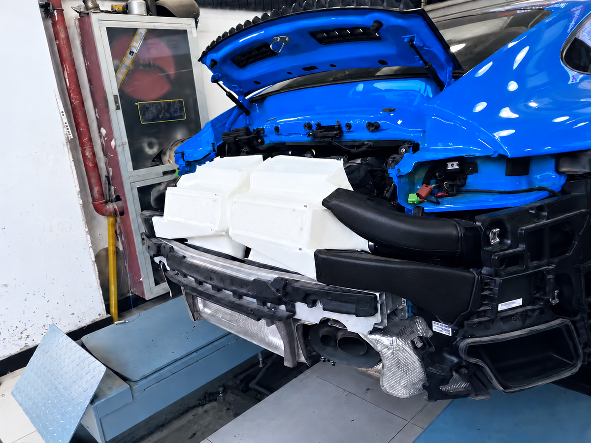 Porsche 992 Turbo performance intercooler installed on vehicle with rear bumper removed